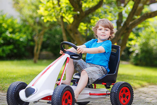 istock Active little boy having fun and driving toy race car 483476372