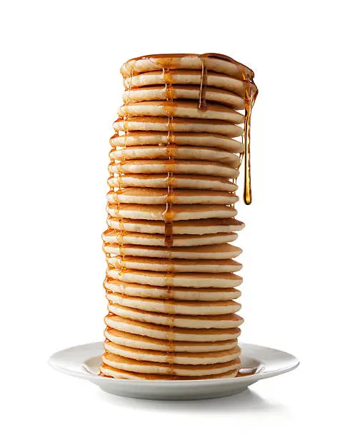 Large stack of pancakes dripping with syrup with clipping path.  Please see my portfolio for other food and drink images. 