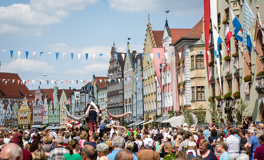 Landshut, Germany - July 13, 2013: Middle age festival, happening every 4 years, recreation of events from Landshuter Hochzeit 1475. Crowd gathering and watching street performers from middle ages.