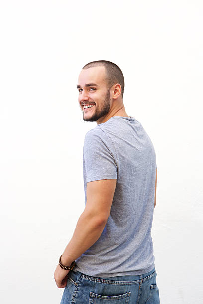 Young man turning around and smiling