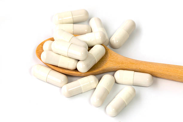 istock Scoop with pills isolated on white background 483479790