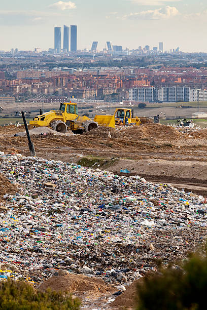 Dump near Madrid Vertical view of machines working in a dump near Madrid. dogger stock pictures, royalty-free photos & images