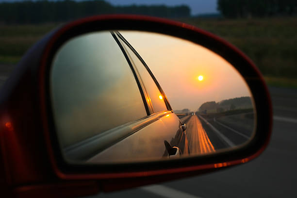 istock Sunset in mirror of car 483480873
