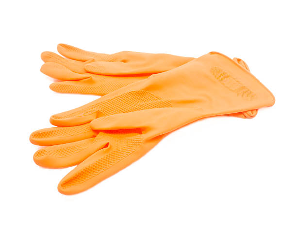istock Two orange rubber gloves. Close-up. Isolated on white background 483481067