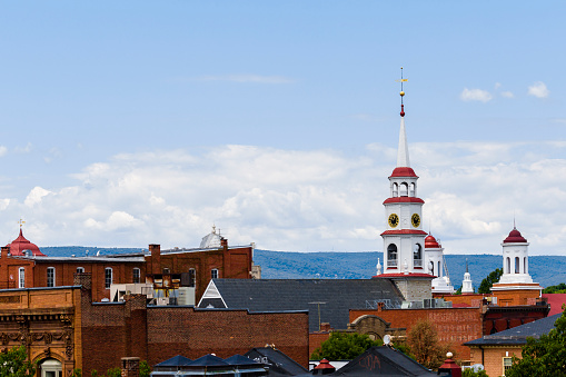 Small Town Steeples and Rooftops, Mountains In Background