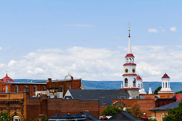 Small Town Steeples and Rooftops, Mountains In Background stock photo
