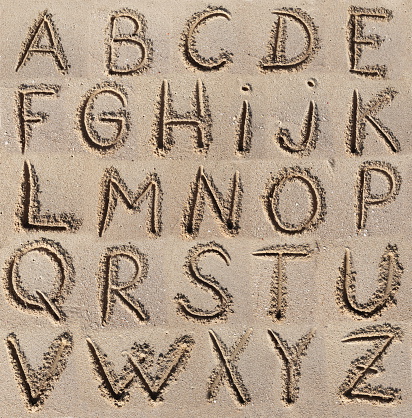 Alphabet (ABC) written on sand.