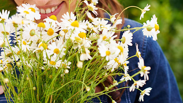 istock Woman with chamomiles 483495338