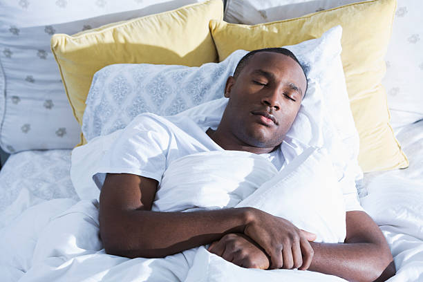 istock Young African American man asleep in bed 483496882