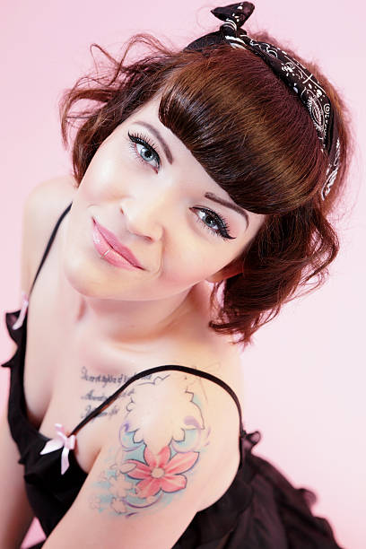 Pinup style woman Beautiful Pinup style woman looking at camera.  Depth of field with focal point on eyes. black pin up girl tattoos stock pictures, royalty-free photos & images