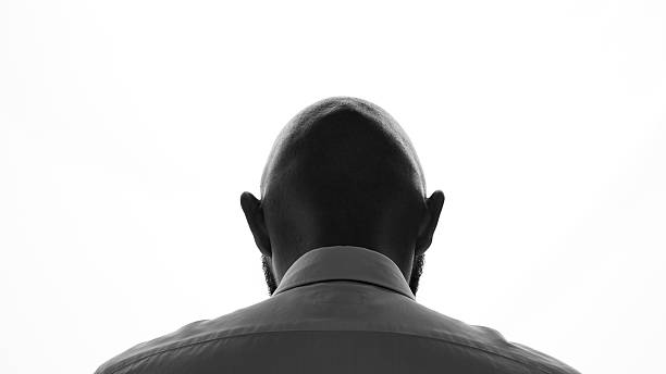 Silhouette of bald man Rear view of bald man on white background back of head photos stock pictures, royalty-free photos & images