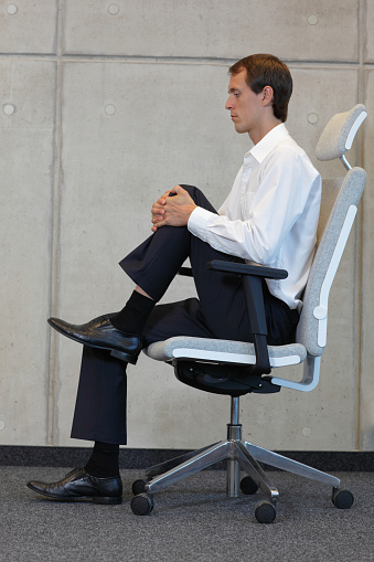 fitness office - business man exercising in office with leg