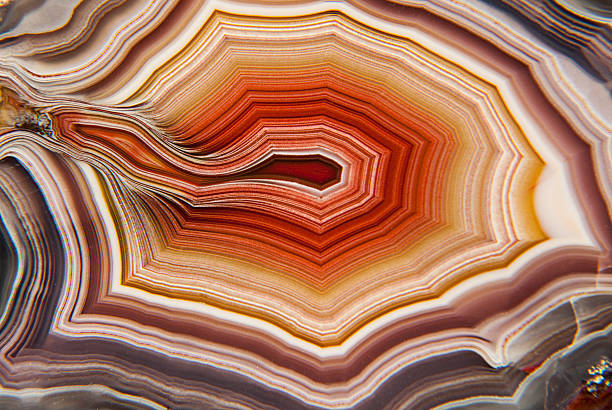 Banded Mexican Agate Geode Macro of red, yellow and purple banding in a Mexican Agate geode  geode photos stock pictures, royalty-free photos & images