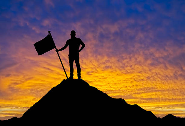 istock Man with flag standing on the top of mountain 483503986
