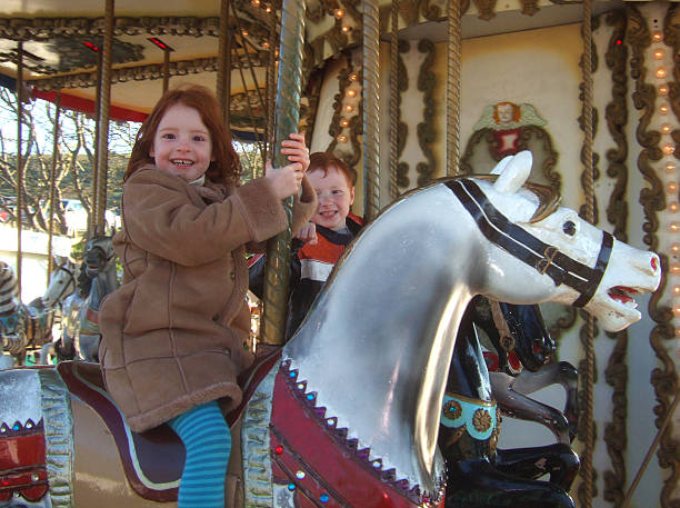istock Image of children on fairground carousel horses 483504729