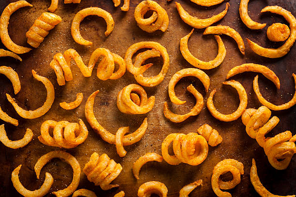 Spicy Seasoned Curly Fries Spicy Seasoned Curly Fries Ready to Eat curly fries stock pictures, royalty-free photos & images