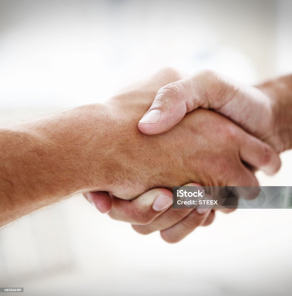 Taking on the business world together! Cropped closeup shot of two businessmen shaking hands Close-up Stock Photo