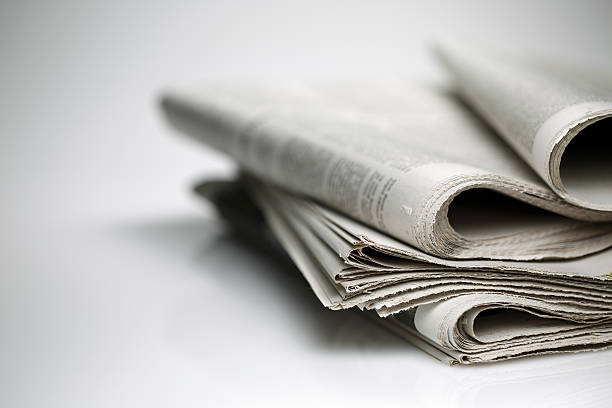 newspaper isolated on white background newspapers against plain background shot with very shallow depth of field stack rock stock pictures, royalty-free photos & images