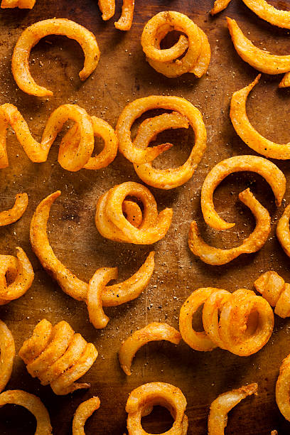 Spicy Seasoned Curly Fries Spicy Seasoned Curly Fries Ready to Eat curly fries stock pictures, royalty-free photos & images