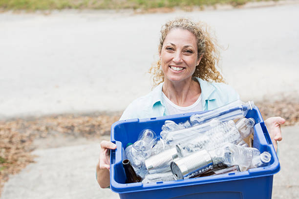 istock Woman carrying recycle bin 483507623