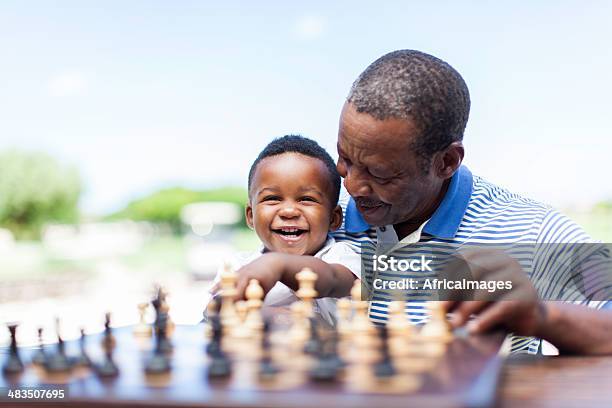 African Grandfather Playing Chess With His Grandson Stock Photo - Download Image Now