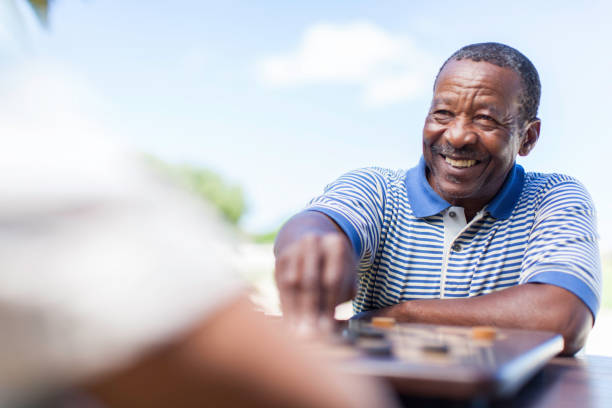 istock African senior chess playing making his move with a smile 483507747