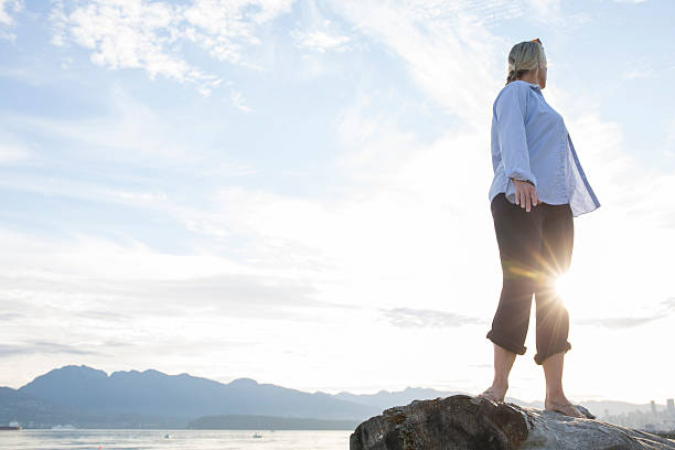 istock Woman looks over her shoulder towards sunrise 483507796