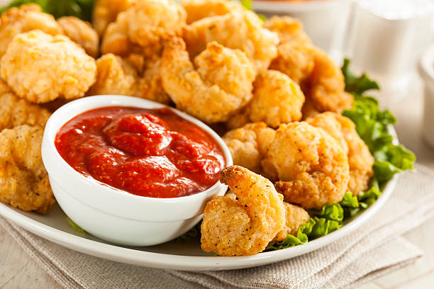 Organic Breaded Popcorn Shrimp Organic Breaded Popcorn Shrimp with Cocktail Sauce breaded photos stock pictures, royalty-free photos & images