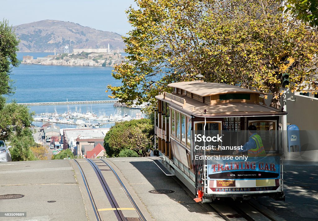 San Francisco-USA,  The Cable car tram San Francisco-USA, November 2nd, 2012: The passengers are going from the station Hyde by the Cable car Tram to the Center of San Francisco. The Cable car is one of the San Francisco Attractions. Taken on Hyde street around 3pm, Nov 2nd, 2012. Alcatraz Island Stock Photo