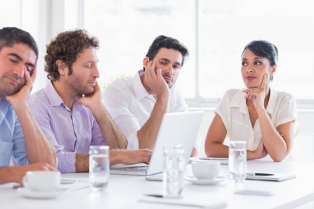 istock Woman watching sleepy executives at conference table 483510649