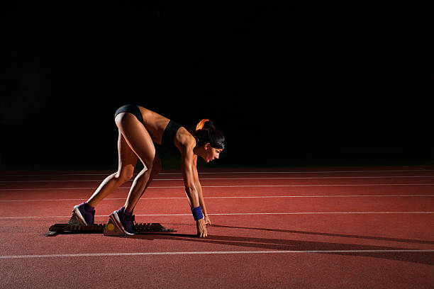 istock Athlete woman running on athletic racetrack 483511176