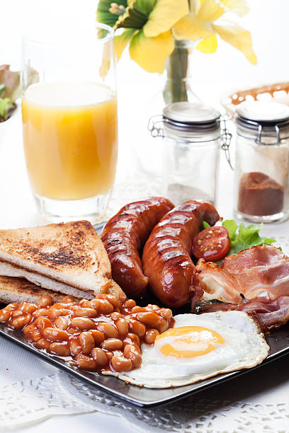istock Full English breakfast with bacon, sausage, egg, beans and juice 483511876