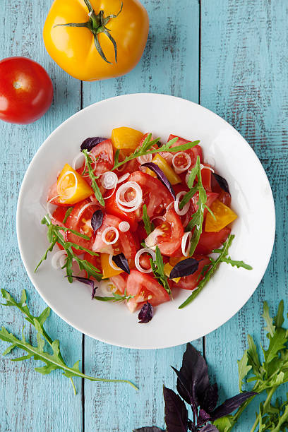 istock Salad with tomatoes onions, arugula and basil 483512118