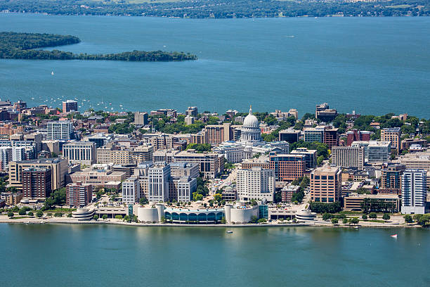 Downtown Madison Wisconsin Isthmus An aerial shot of the strip of Madison Wisconsin's downtown showing both the Monona Terrace and Capitol buildings as well as Picnic Point in the far background. Also shows parts of both Lakes Monona and Mendota.  lake monona photos stock pictures, royalty-free photos & images