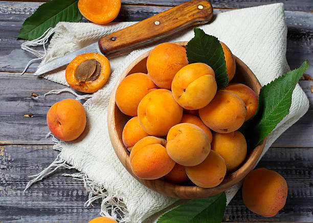 istock Fresh ripe apricots in wooden bowl 483520922