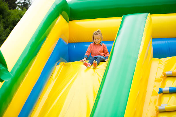 istock little girl playing on a trampoline. 483524086