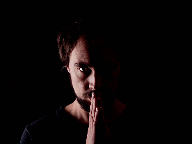 istock Low key image of a bearded man praying 483526573