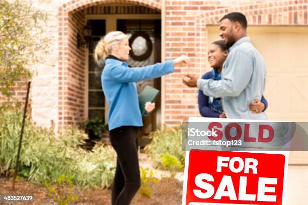 Real Estate African Descent Couple Buys Home Real Estate Agent Gives Key Stock Photo - Download Image Now