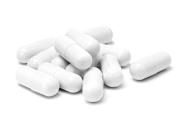 istock White medicine capsules isolated on white background 483527778
