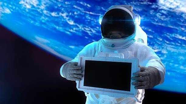 Astronaut Astronaut holds in hands the electronic display. cosmonaut photos stock pictures, royalty-free photos & images