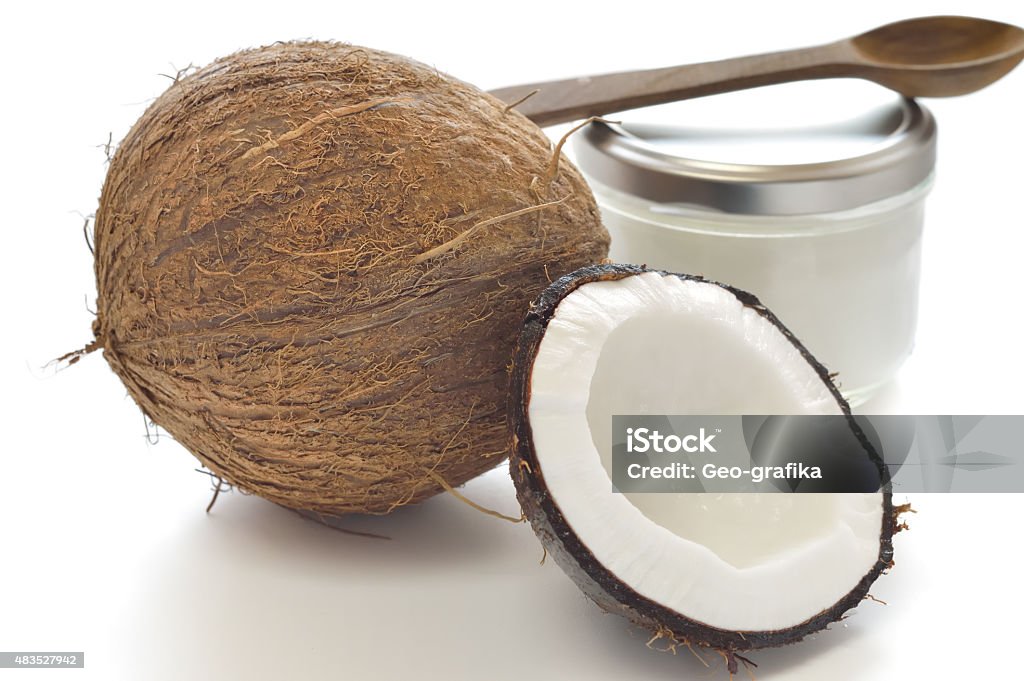 Coconut and organic coconut oil Coconut and organic coconut oil in a glass jar on white background. 2015 Stock Photo