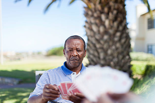 istock African senior playing a cards 483528183