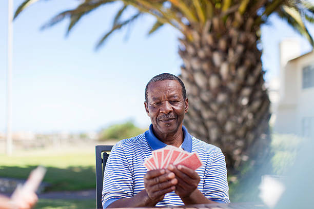 istock African senior playing a cards 483528199