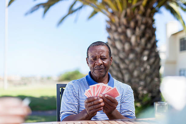 istock African senior playing a cards 483528215