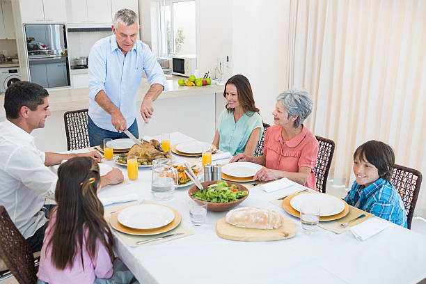 istock Family at dining table for christmas dinner 483528371
