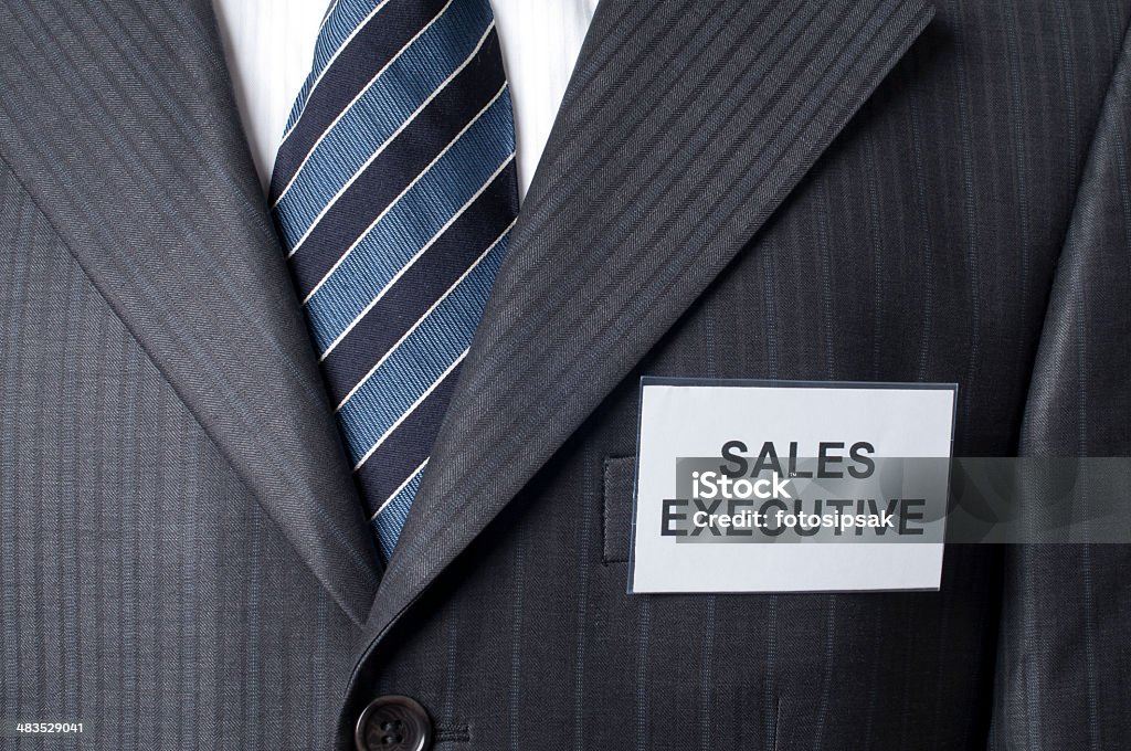 sales executive id card badge with "sales executive" text on the businessman's jacket Adult Stock Photo
