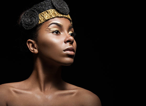 istock African girl with bright makeup and creative gold accessories on 483529698