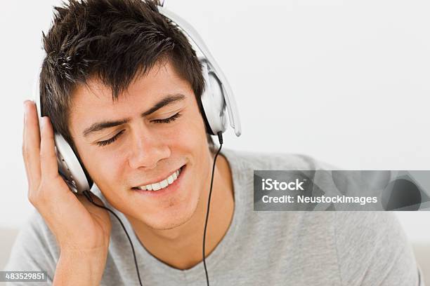 Young Man Listening Music Stock Photo - Download Image Now - Eyes Closed, Headphones, Listening