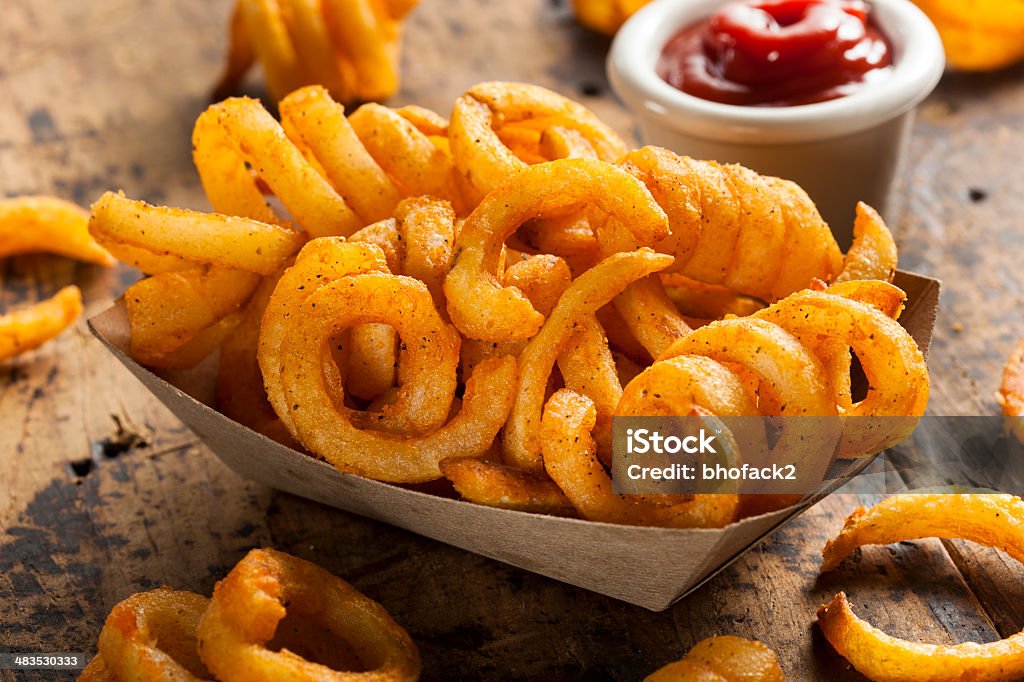 Spicy Seasoned Curly Fries Spicy Seasoned Curly Fries Ready to Eat Curly Fries Stock Photo