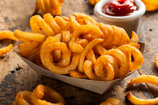 Spicy Seasoned Curly Fries Spicy Seasoned Curly Fries Ready to Eat curly fries stock pictures, royalty-free photos & images